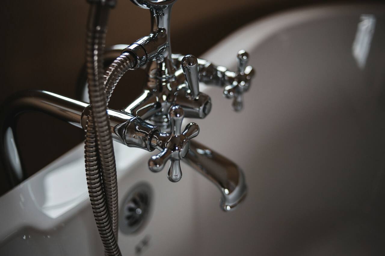 Close-up of a plumbing fixture being serviced